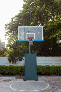 Basketball hoop against trees in park