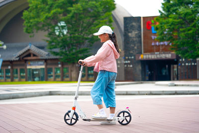 Portrait of young woman riding bicycle on street