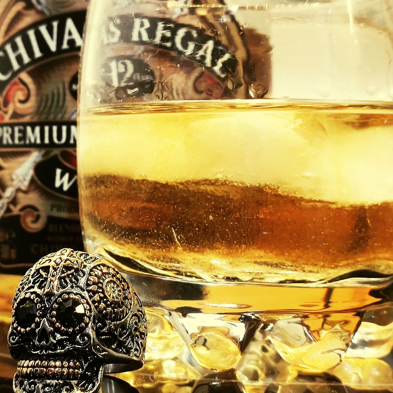 CLOSE-UP OF BEER GLASS ON TABLE AGAINST WALL