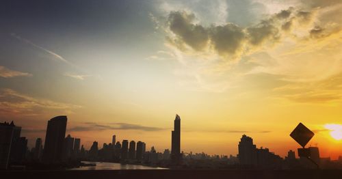 Silhouette buildings against sky during sunset