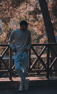 Rear view of man standing against railing