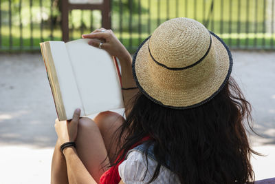 Midsection of woman holding book