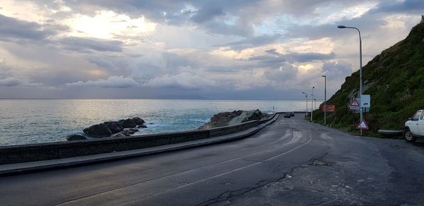 Road by sea against sky