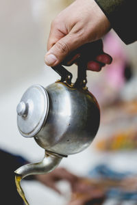 Berber man offers traditional mint tea to guests in marrakesh, morroco