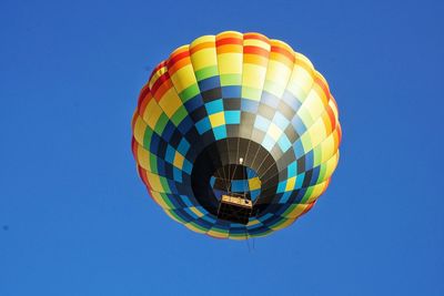 Low angle view of hot air balloon against clear blue sky