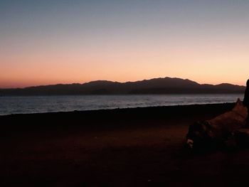 Scenic view of sea against clear sky during sunset