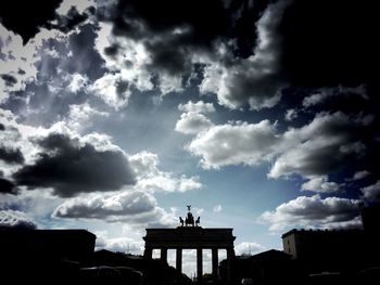 Low angle view of building against cloudy sky