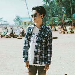 Young man wearing sunglasses standing outdoors