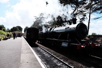 Train on railroad track against sky