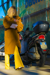 Rear view of people standing on road