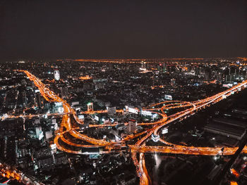 High angle view of illuminated city buildings at night
