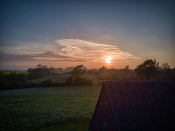 Scenic view of field against sky during sunset