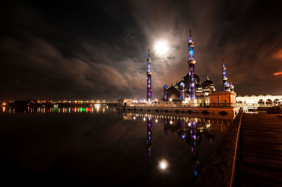 View of illuminated building against cloudy sky