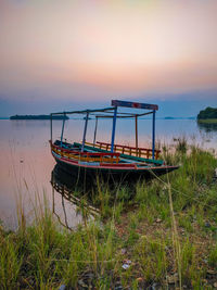 A boat standing on riverbank after sunset