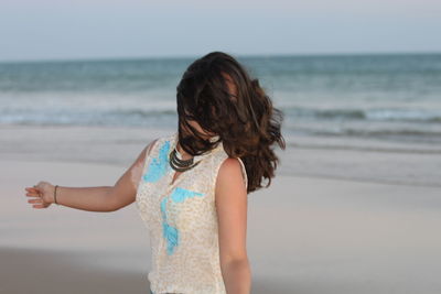 Woman with tousled hair at beach