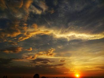 Low angle view of dramatic sky during sunset