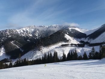 Scenic view of snow covered mountains against sky