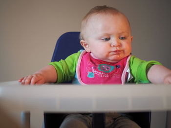 Portrait of cute baby sitting at home