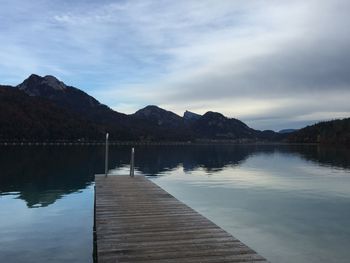 Pier over lake against sky