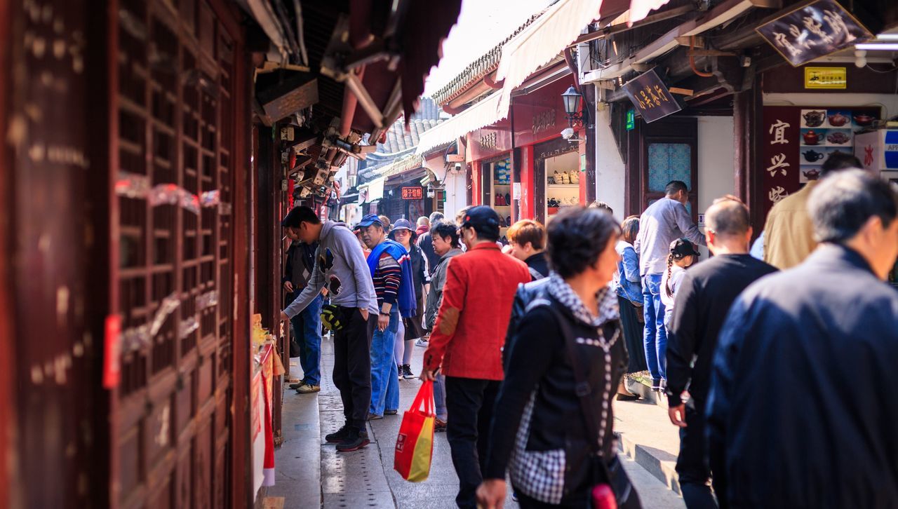 group of people, city, architecture, building exterior, crowd, large group of people, built structure, men, walking, adult, street, real people, women, city life, lifestyles, market, transportation, outdoors, leisure activity, street market