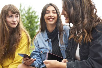 Portrait of smiling young woman using smart phone