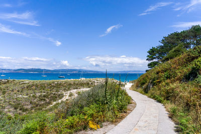 Footpath by sea against sky in cies islands