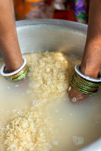 Shot of a random lady cooking rice 