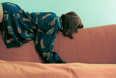 Woman lying on sofa at home