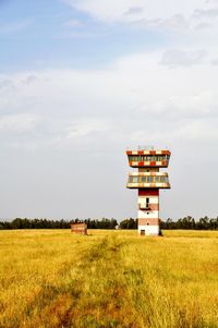 Lifeguard hut on field against sky