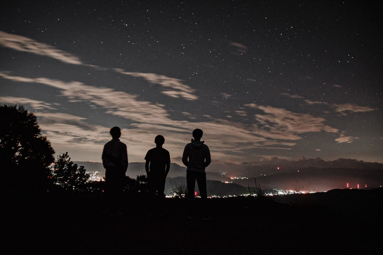 sky, night, nature, togetherness, men, leisure activity, cloud - sky, star - space, beauty in nature, real people, silhouette, scenics - nature, group of people, standing, lifestyles, people, space, friendship, outdoors, astronomy