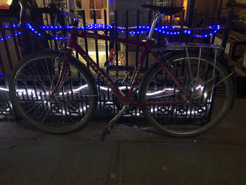 Bicycle parked in parking lot at night