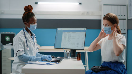 Midsection of female doctor working in laboratory