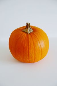 Close-up of pumpkin against orange background