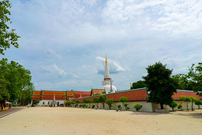 Traditional building by trees against sky