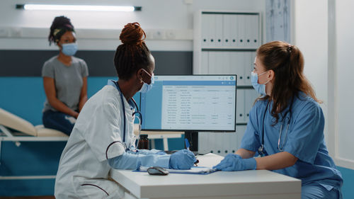 Doctor and nurse wearing mask working at clinic