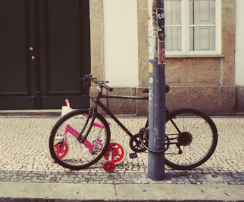 Bicycle against window in city