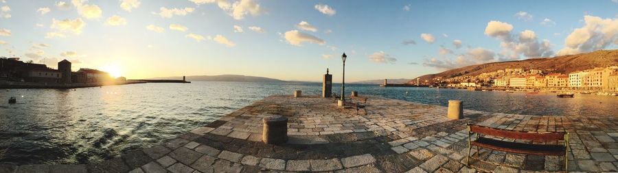 Panoramic view of beach against sky during sunset