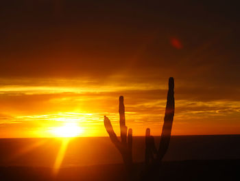 Scenic view of silhouette land against sky during sunset