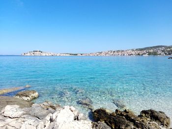 Scenic view of sea against clear blue sky