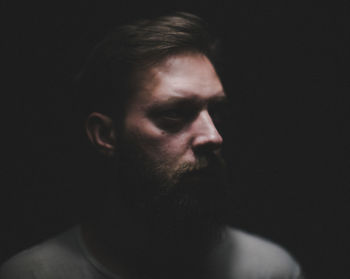 Close-up of man against black background