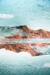 Reflection of rock formation in sea