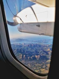 Aerial view of landscape seen through airplane window