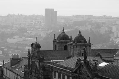 Historic building in city against sky during foggy weather