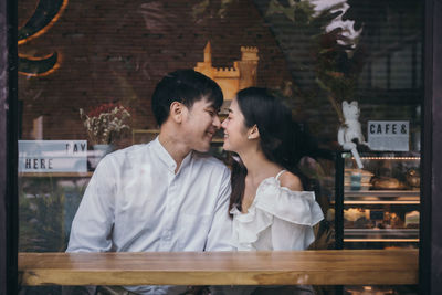 Young couple kissing in restaurant