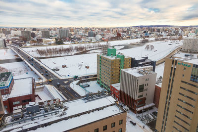 High angle view of buildings in city against sky