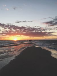 Scenic view of beach against sky during sunset