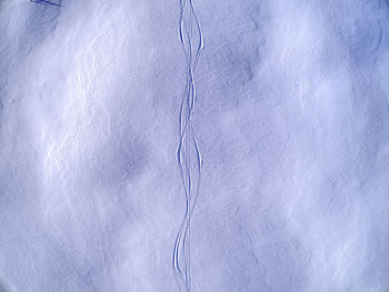 Directly above shot of tire tracks on snowy field