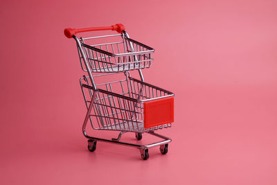 Close-up of metallic structure against pink background