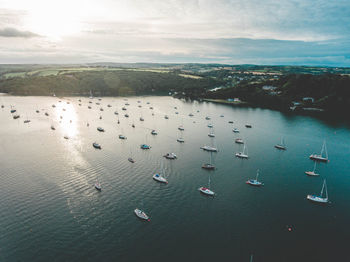 High angle view of birds in sea against sky