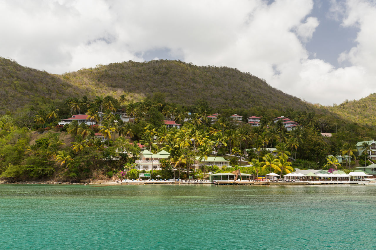 SCENIC VIEW OF SEA BY SWIMMING POOL AGAINST BUILDINGS